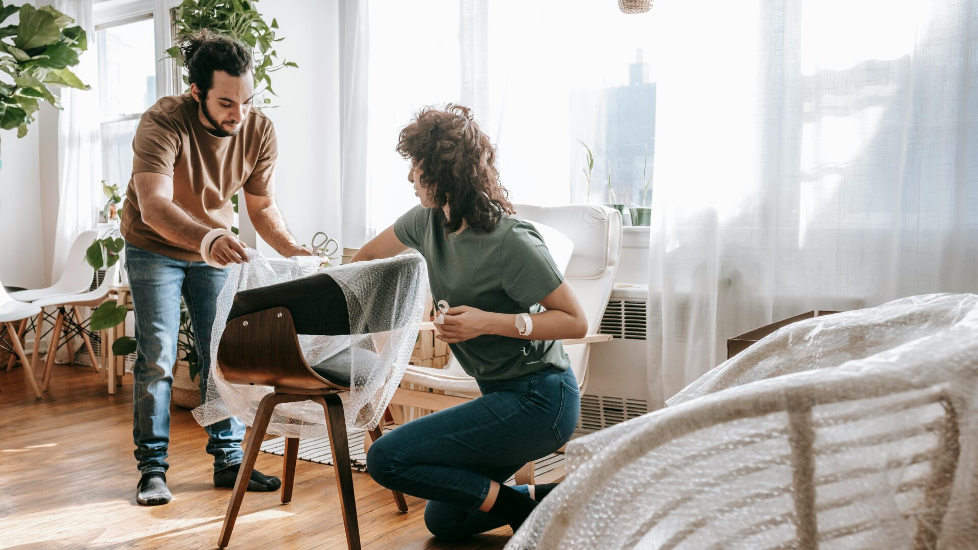 two people protecting their furniture